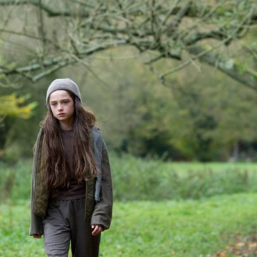 Molly walking in woods - still from movie